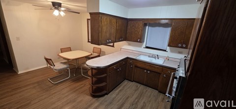A kitchen with wooden cabinets and a white countertop.