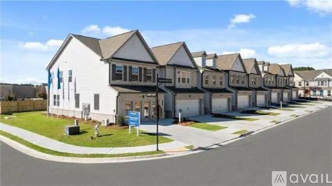 A row of houses with a blue sign in front of them.