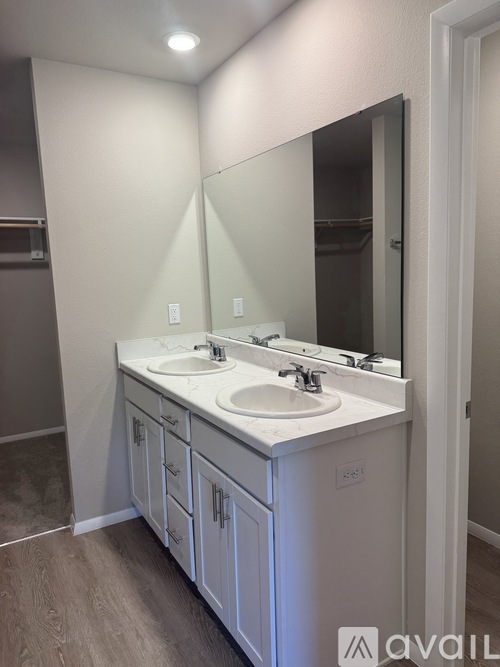 A bathroom with two sinks and a large mirror.