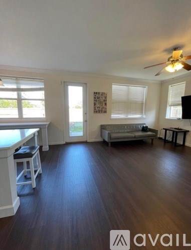 A living room with a grey couch and a television.