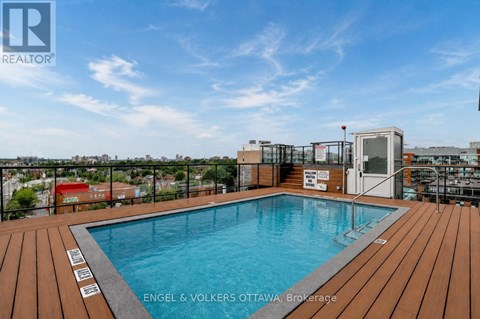 A pool on a deck with a sign that says "ENGEL & VOLKERS OTTAWA Brokerage".