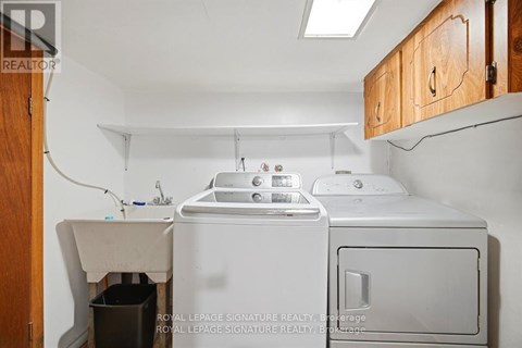 A small laundry room with a washer and dryer.