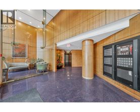 A lobby with a purple floor and a wooden wall.