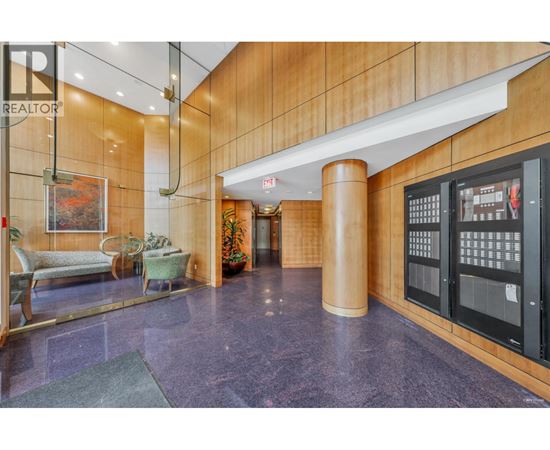 A lobby with a purple floor and a wooden wall.