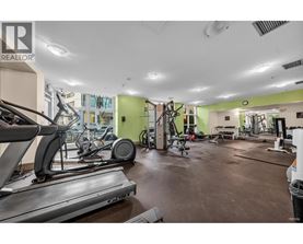 A gym with treadmills, weights, and exercise equipment.