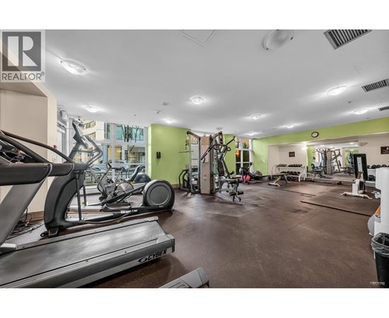 A gym with treadmills, weights, and exercise equipment.