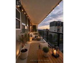 A balcony with a table, chairs, and plants.