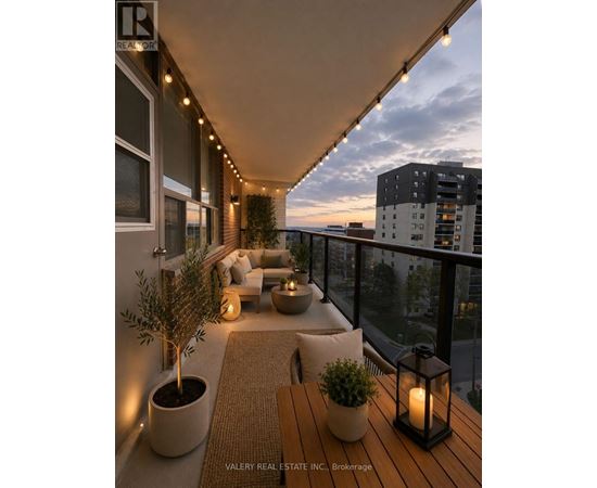A balcony with a table, chairs, and plants.