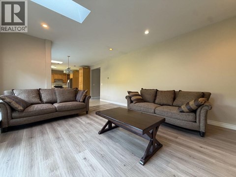 A living room with a brown couch and a coffee table.