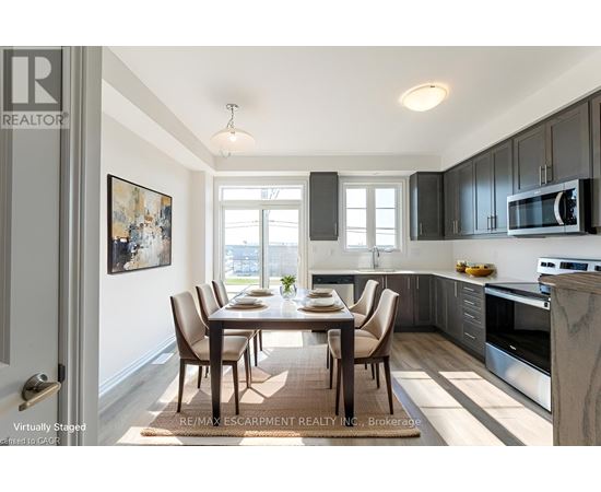 A modern kitchen with a dining table and chairs.