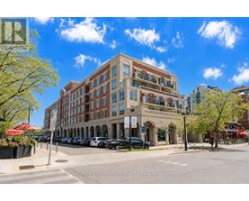 A street view of a multi-story building with a parking lot in front.