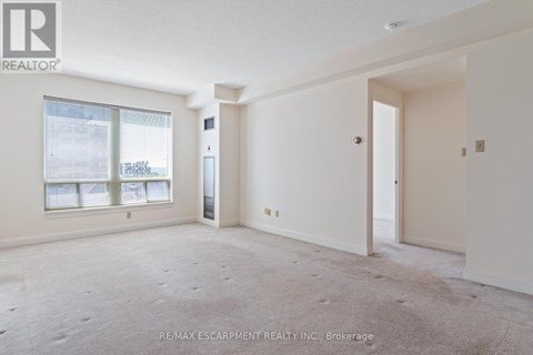 A spacious room with a door and a window.