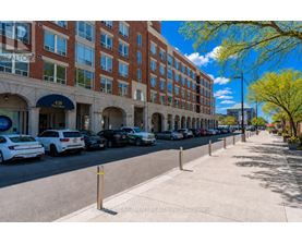 A street view of a building with cars parked in front.
