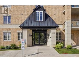 The entrance to a building with a black awning and a sign that says RE/MAX Abbottowne Realty Corp, Brokerage.