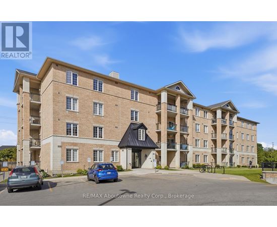 A multi-story apartment building with a parking lot in front.