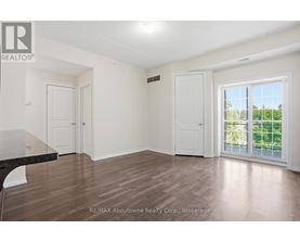A room with a sliding glass door leading to a balcony.