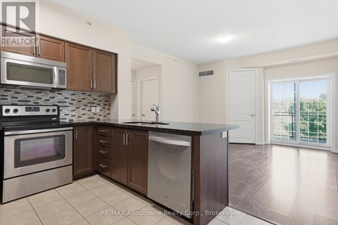 A kitchen with a stove top oven, microwave, and dishwasher.