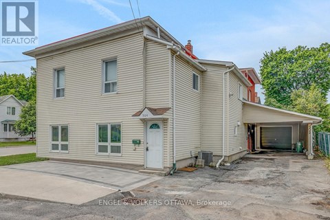 A two-story house with a garage is for sale.