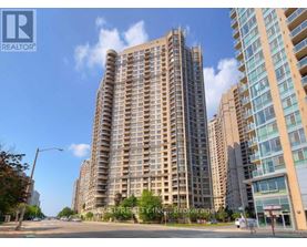 A tall residential building with a balcony on the 10th floor.