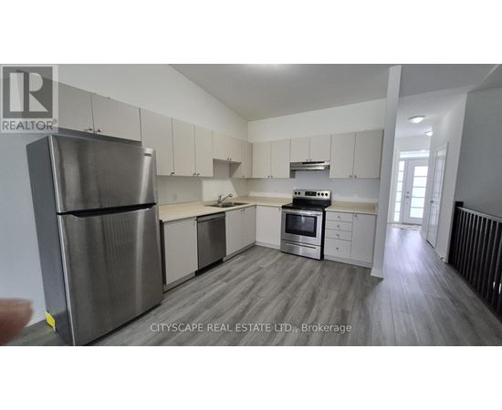 A modern kitchen with stainless steel appliances and white cabinets.
