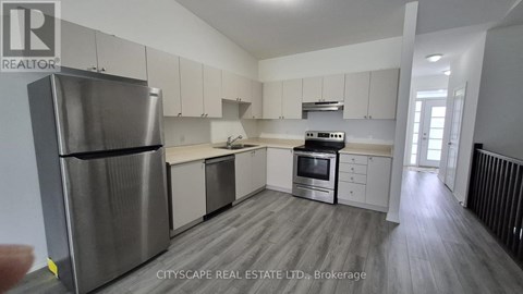 A modern kitchen with stainless steel appliances and white cabinets.