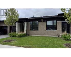 A modern house with a black roof and a brick facade.