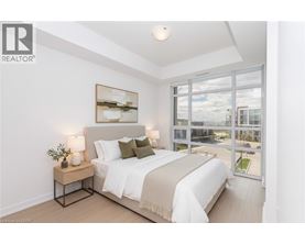 A bedroom with a large bed and a view of the outside.