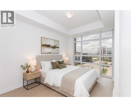 A bedroom with a large bed and a view of the outside.