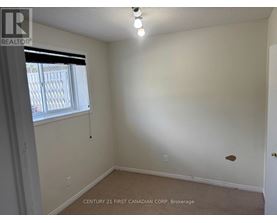 A room with a window and a door, with a sign that says "REALTOR".