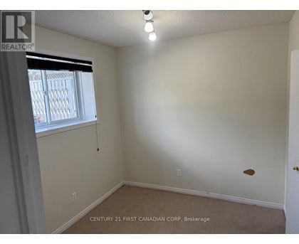 A room with a window and a door, with a sign that says "REALTOR".