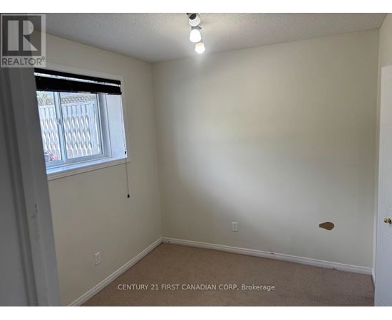 A room with a window and a door, with a sign that says "REALTOR".