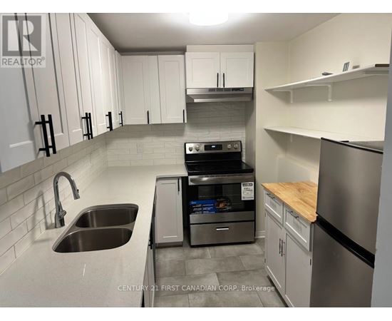 A kitchen with a stainless steel dishwasher and refrigerator.