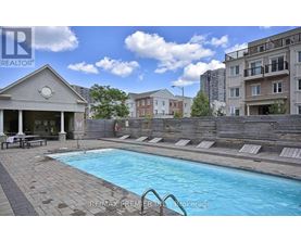 A pool with a slide and a building in the background.