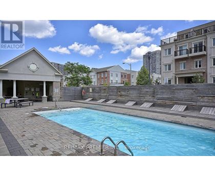A pool with a slide and a building in the background.