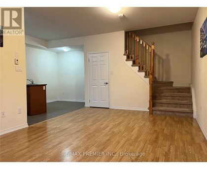 A room with a staircase and a white door.