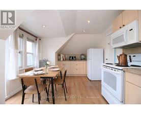 A kitchen with a table set for two with a window behind it.