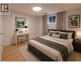 A bedroom with a large bed and a desk with a chair.