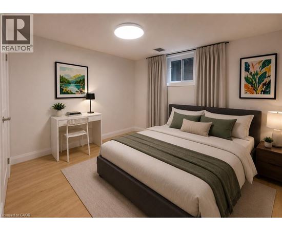 A bedroom with a large bed and a desk with a chair.