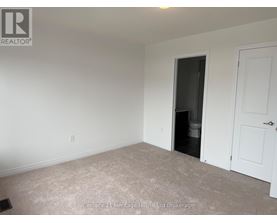 A room with a doorway leading to a dark space.