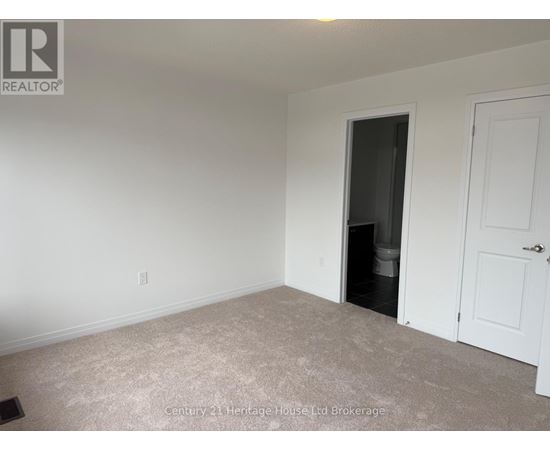 A room with a doorway leading to a dark space.
