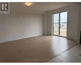 Empty room with a sliding glass door leading to a construction site.