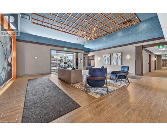 A spacious waiting area with a wooden floor and a skylight.