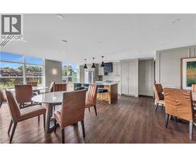 A modern dining room with a large table and chairs.