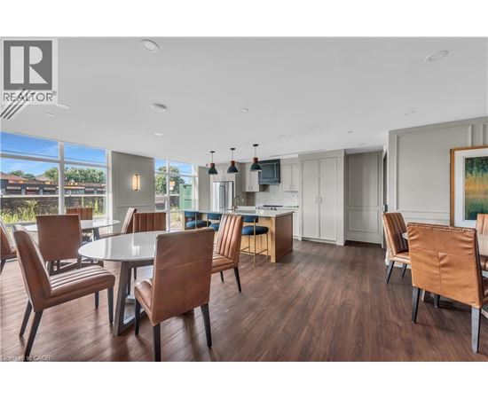 A modern dining room with a large table and chairs.