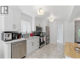 A kitchen with white cabinets and appliances.