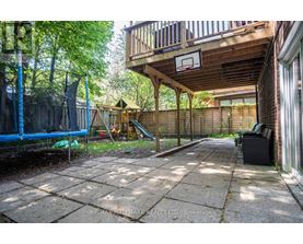A backyard with a basketball hoop and a slide.