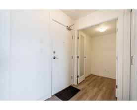 A white door with a black mat in front of it.