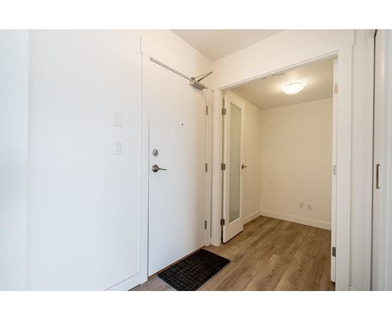 A white door with a black mat in front of it.