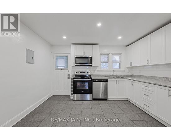 A kitchen with white cabinets and a stainless steel dishwasher and oven.