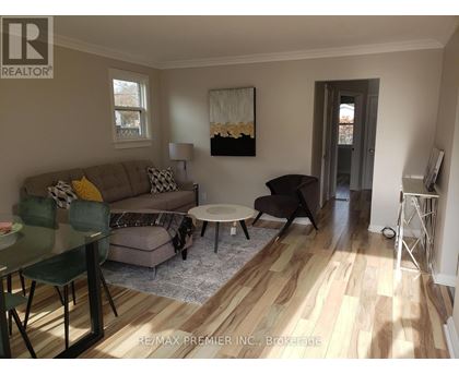 A living room with a couch, chairs, and a coffee table.